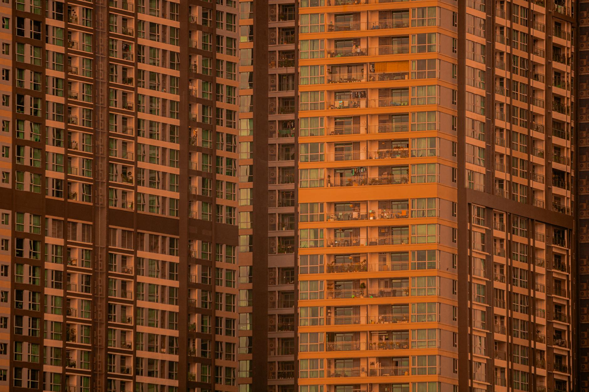 Close-up view of modern high-rise apartment buildings at sunset, highlighting the urban architecture.