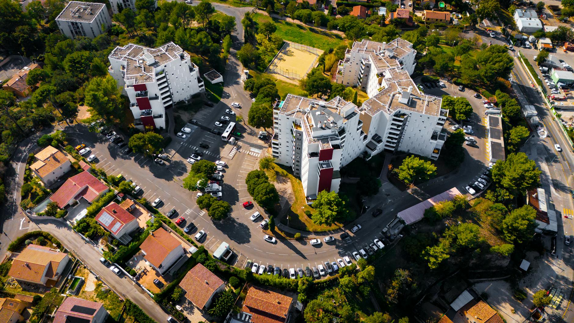 Aerial view of a residential apartment complex in Marseille, France, surrounded by lush greenery.