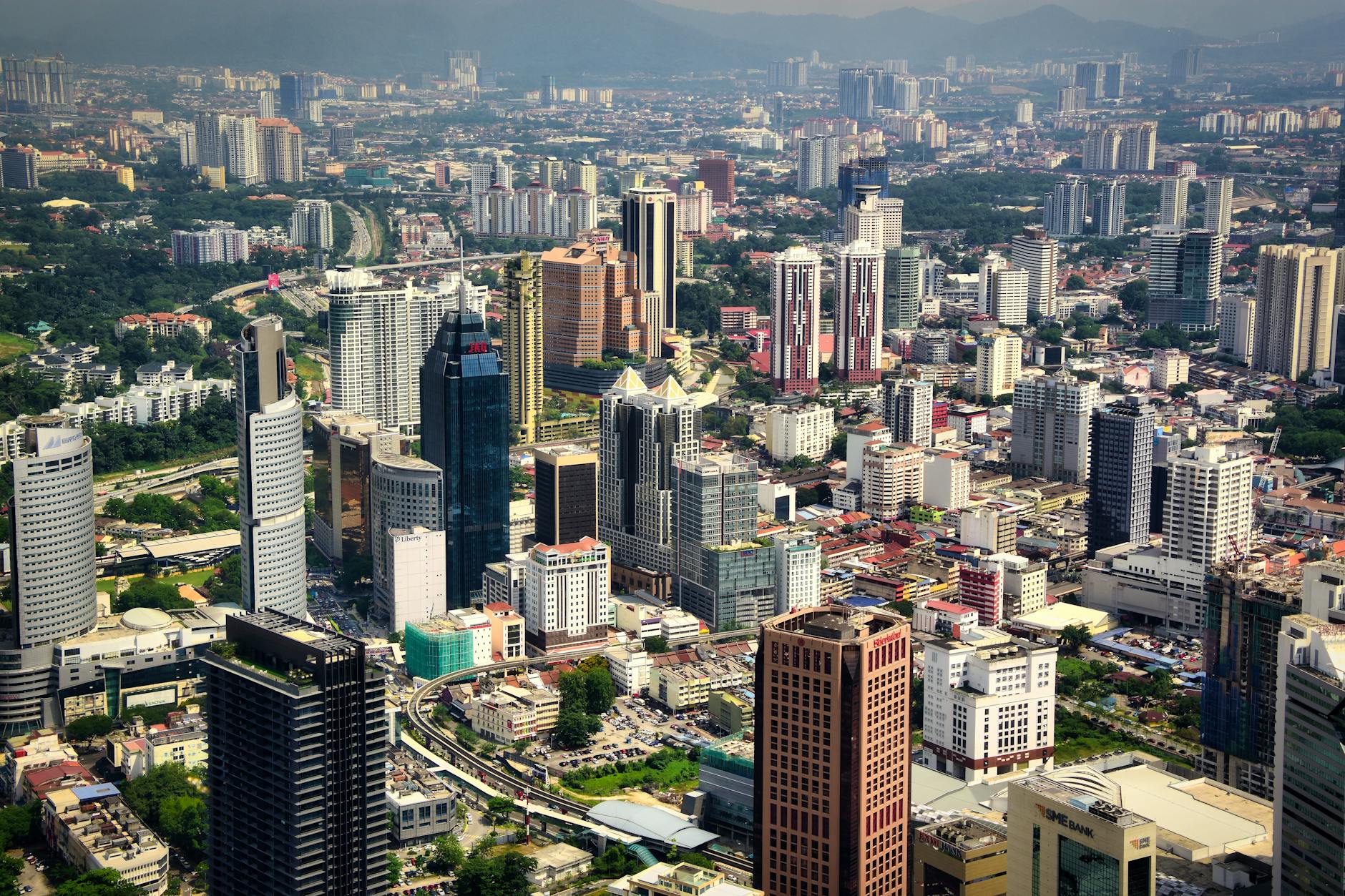 Vibrant aerial view of Kuala Lumpur's modern skyline with towering skyscrapers.