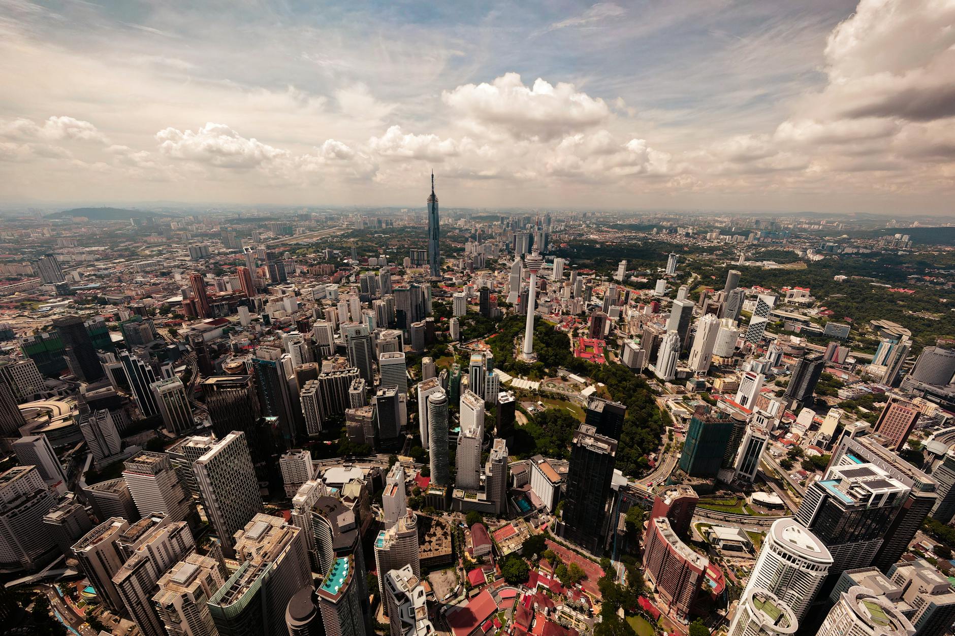 Stunning aerial view of Kuala Lumpur's cityscape featuring iconic skyscrapers and lush greenery.